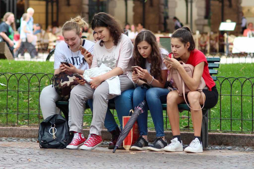 adolescentes menores mirando el móvil
